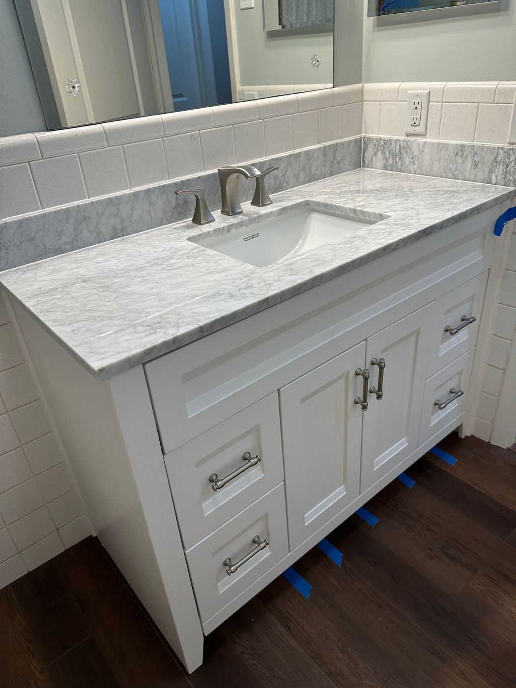 Bathroom vanity: White shaker vanity with marble top